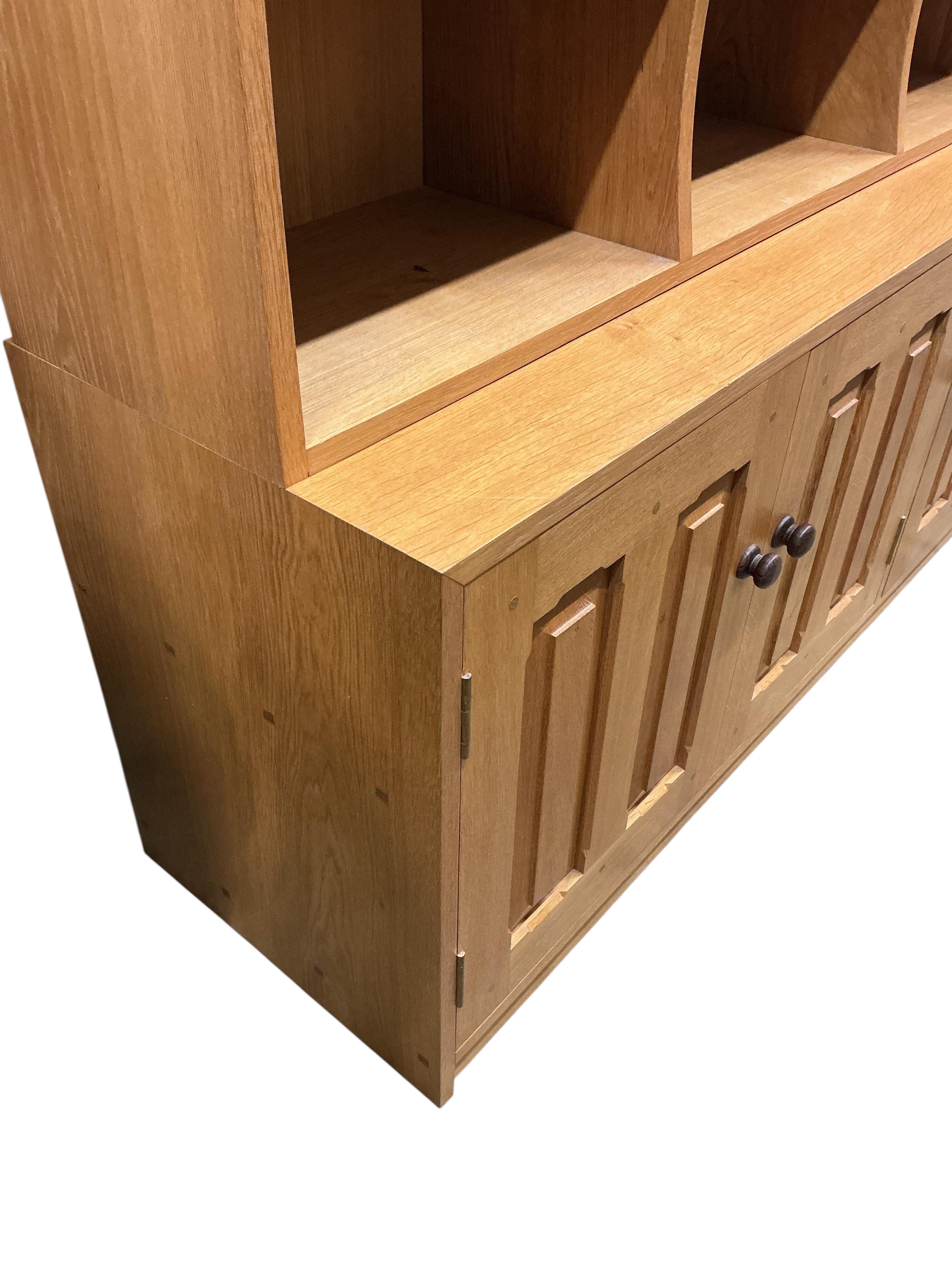 A Contemporary bespoke oak open bookcase, cupboards below, width 141cm, depth 46cm, height 169cm